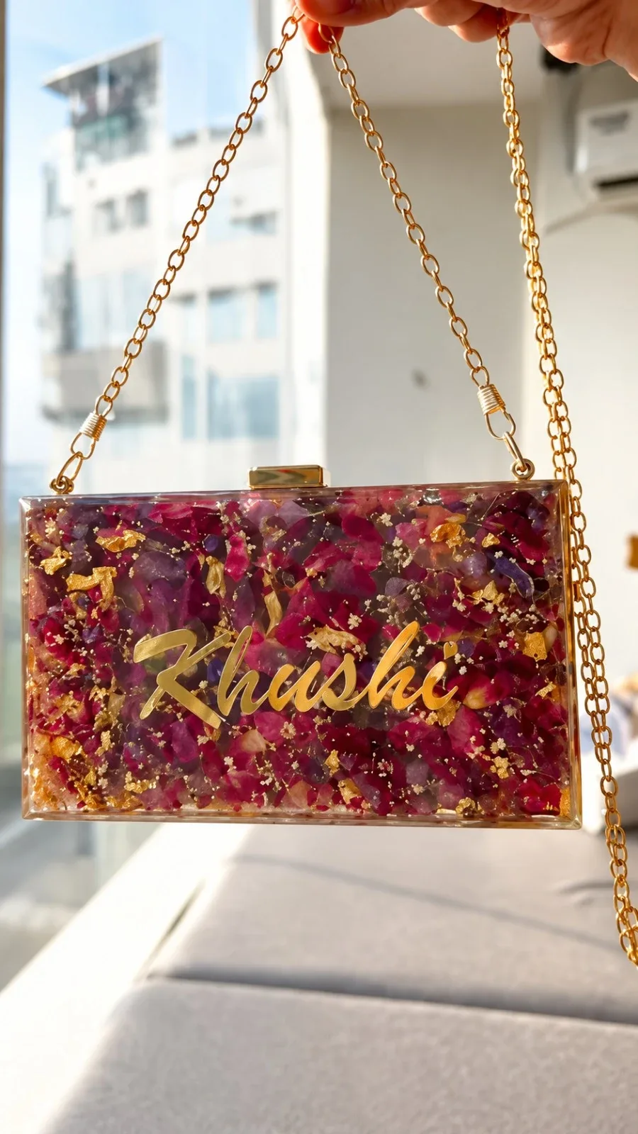 A bridal resin clutch made with the roses from her proposal, with rose petals, gold leaf and her name in gold